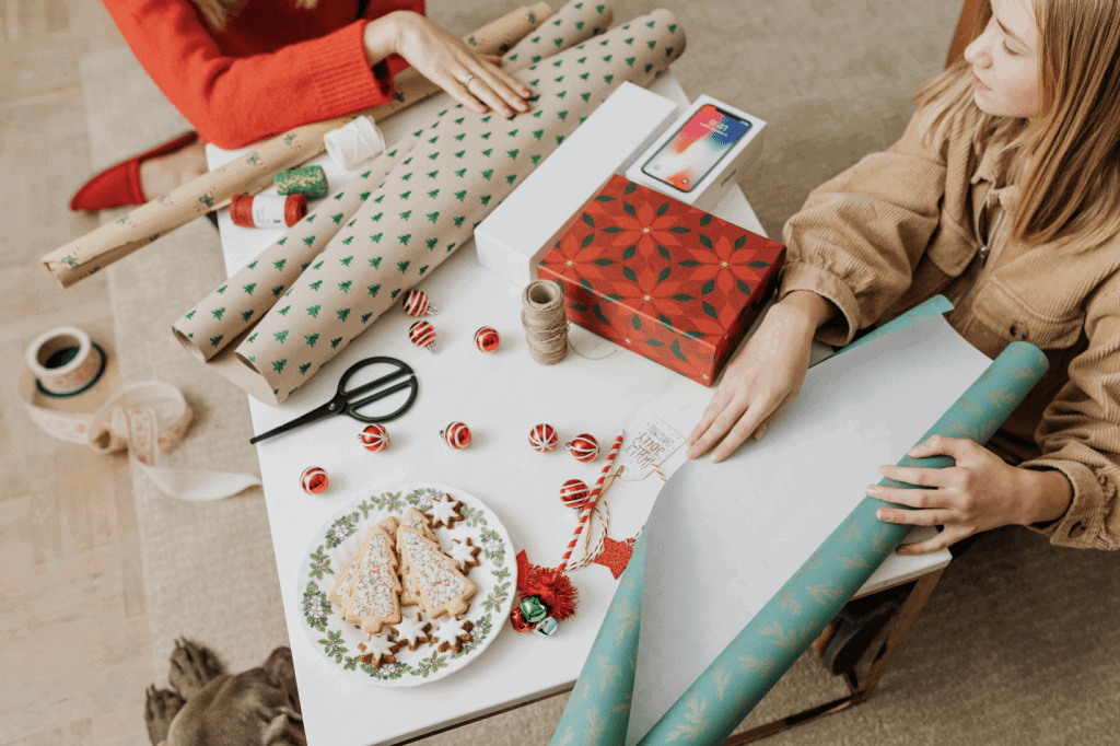 Mental health tip from Tampa Counseling Place in Tampa, Florida: Build connection through shared activities, shown here as a joyful group gathering together to wrap holiday presents, demonstrating the therapeutic value of quality time