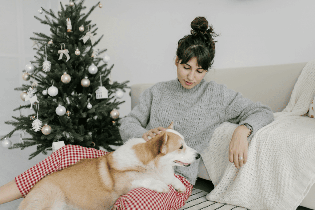 Mental health tip from Tampa Counseling Place in Tampa, Florida: Find comfort in pet companionship, illustrated by a peaceful moment of a person relaxing on their couch with their therapeutic support dog by their side