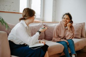 young woman talking with therapist
